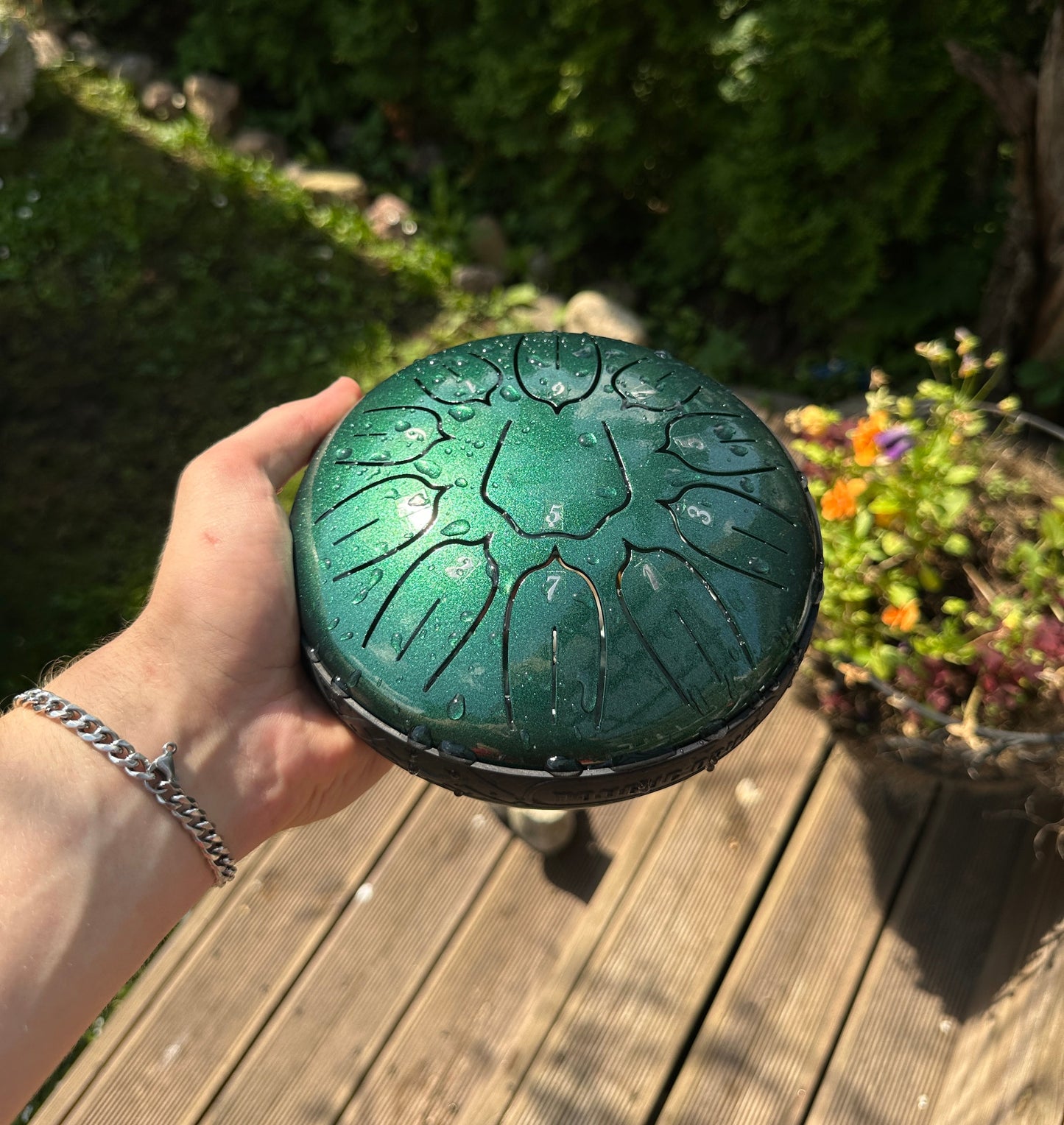 Chakra steel tongue drum 6 inch 11 tone — green, held in hand